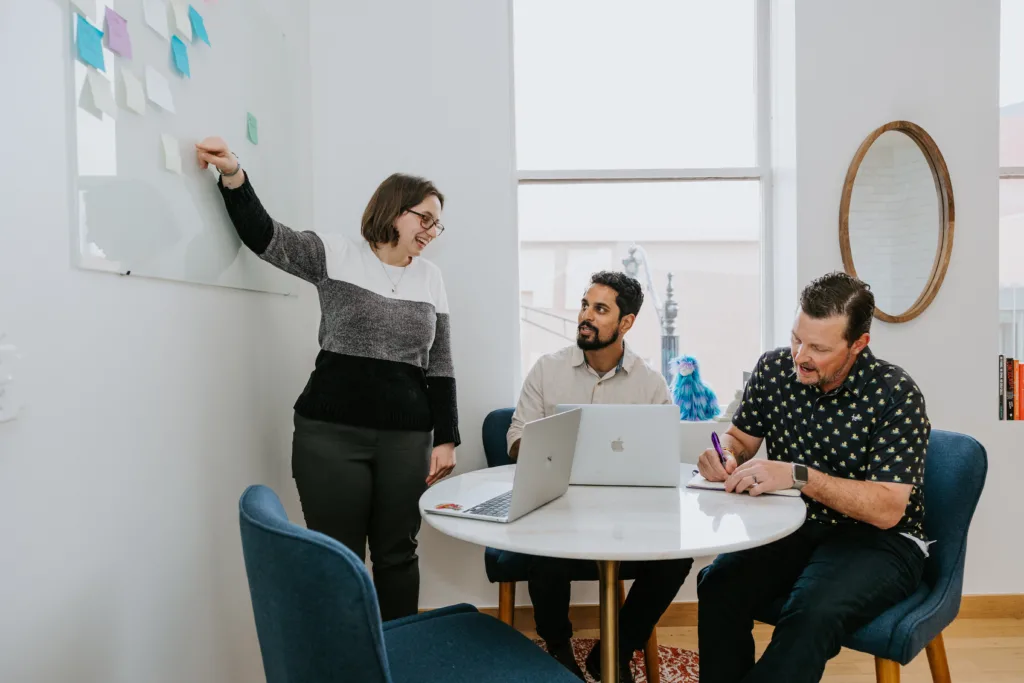 5 Ways to Personalize the Mentoring Experience 4 Two men and a woman in a group mentoring sessions aligning on topics that will improve the mentoring experience.