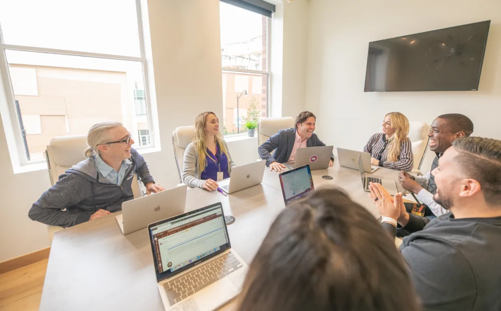 How to Improve Succession Planning with a Mentoring Strategy 5 Team meeting of executives in an office discussing an executive succession planning